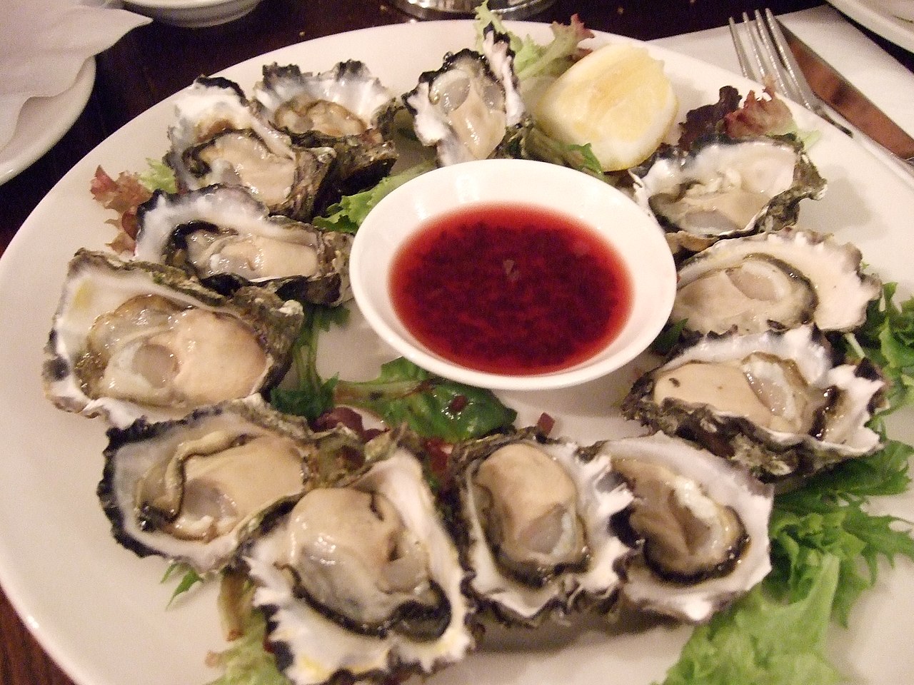 One dozen raw oyster appetizer plate.
